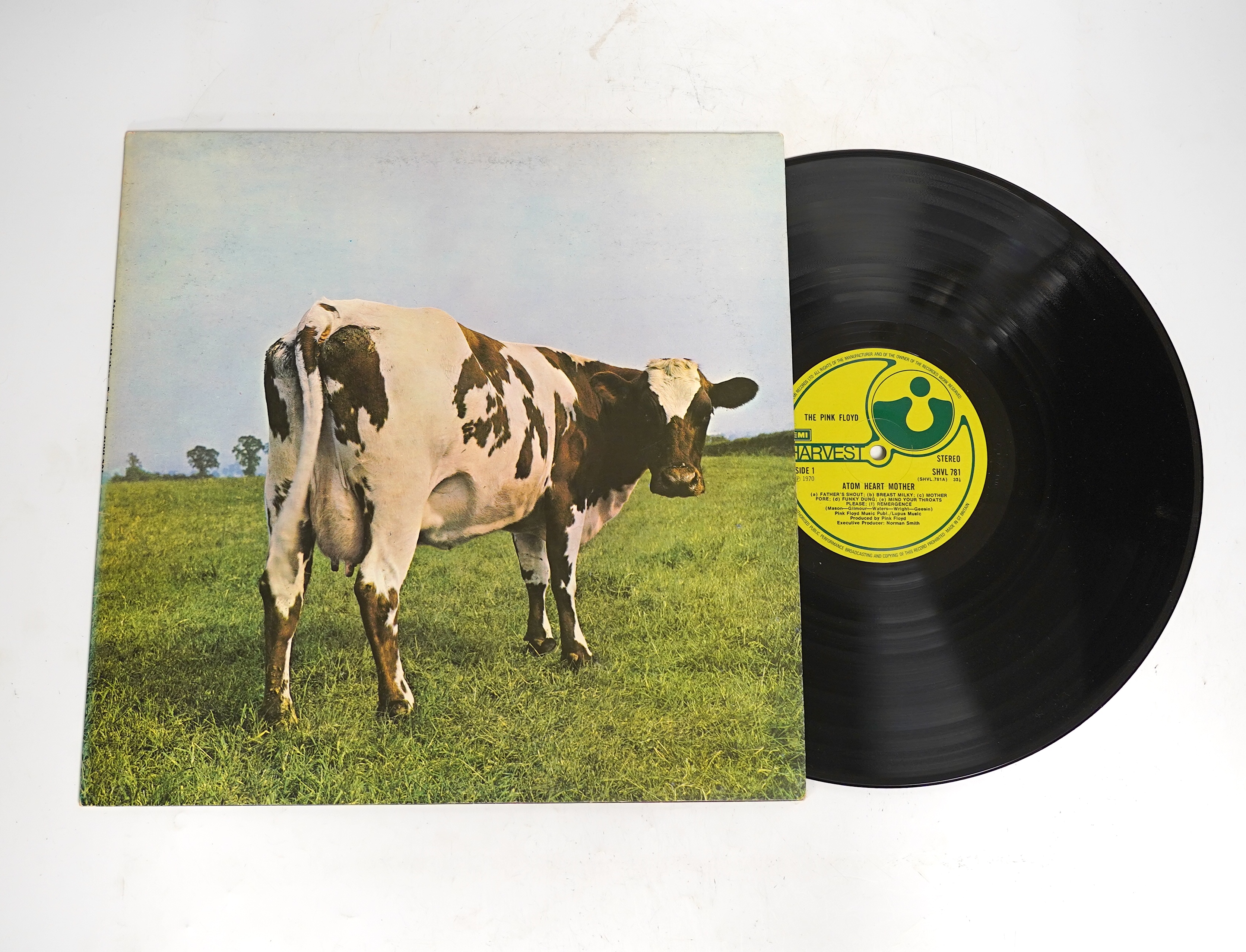 Three Pink Floyd LP record albums; The Wall, SHDW 4111, Dark Side of the Moon, SHVL804, with both posters and two postcards, Atom Heart Mother, SHVL781